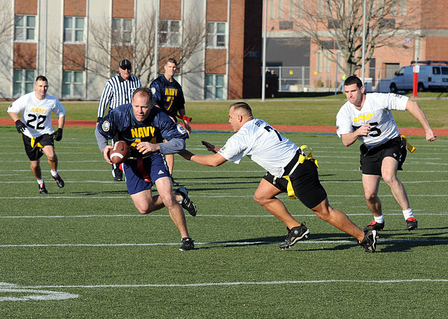 File:US Navy 111202-N-FC065-001 Cmdr. Bill Mallory tries for more yards after a reception during a flag football game celebrating the annual Army-Navy f.jpg