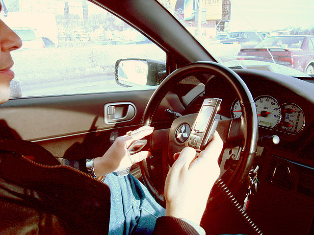 File:Hand held phone in car.JPG